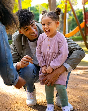 A volunteer smiling with a child at our residential facility.